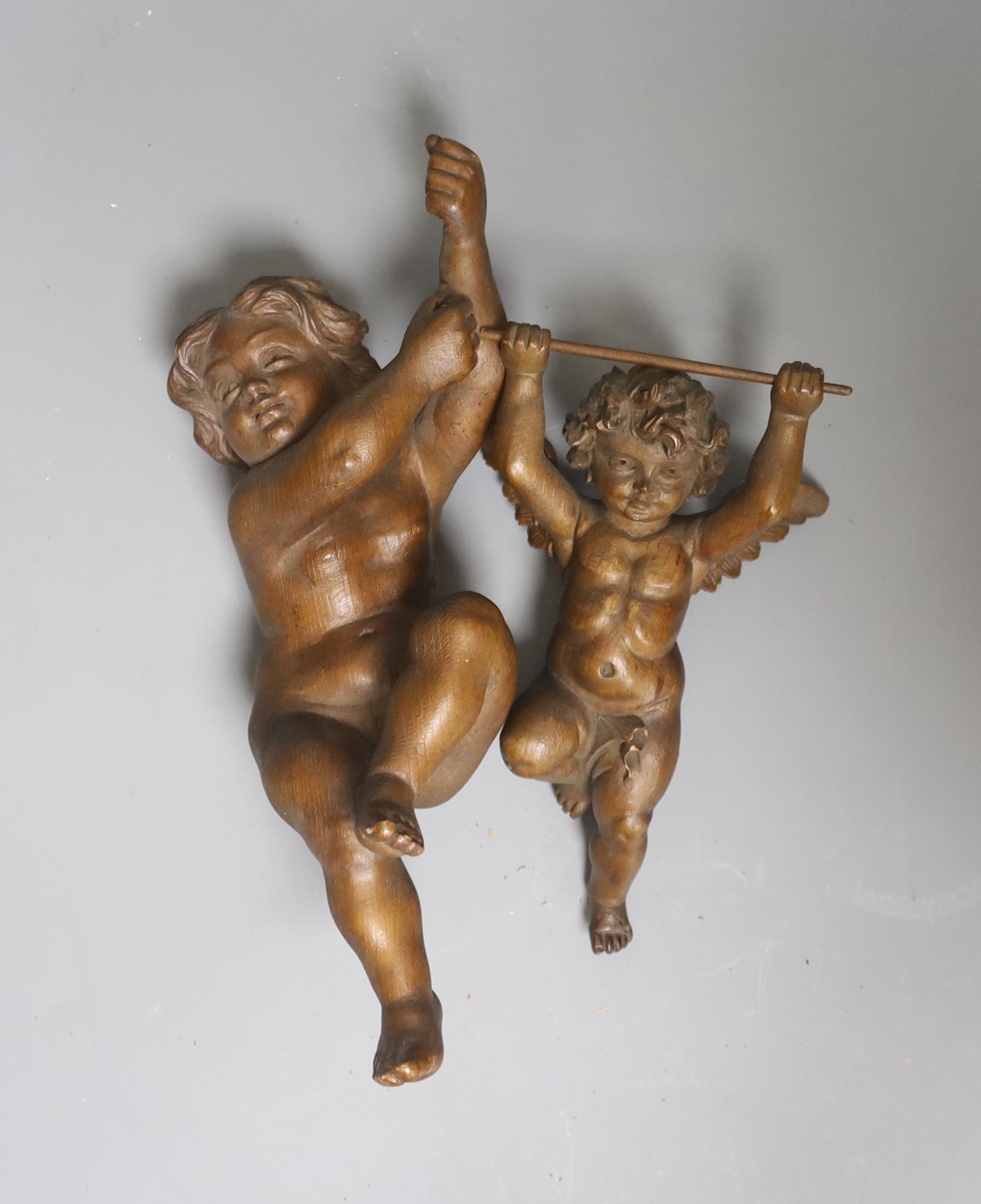 Two carved beech figures of cherubs 27cm